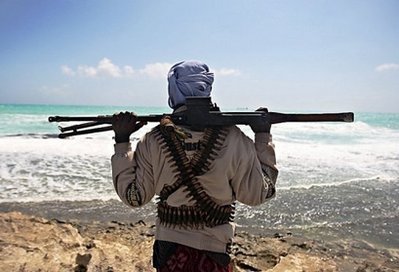 A pirate keeps watch along the coastline at Hobyo town, northeastern Somalia, in January 2010. Pirates … 