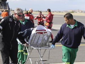 NSRI rescue swimmer Kobus Barnard and two paramedics attend to the Ukrainian captain, who has acute renal failure. A replacement captain was lowered to the tanker. Photo by Michael Walker