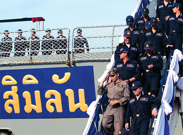 Sailors disembark from HTMSSimilan which, along with HTMSPattani , joined the international anti-piracy operation off Somalia.