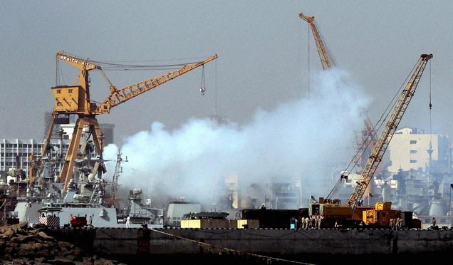 Smoke billows out of the naval dockyard following fire broke out in the naval warship INS Vindhyagiri after it collided with a merchant vessel in Mumbai, on Monday. Photo: PTI 