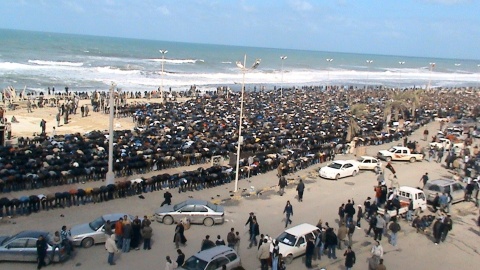 A photograph made available on 24 February 2011, shows Libyans performing prayers as they are gathered in a protest on the seaside in Benghazi, Libya, 21 February 2011. EPA/BGNES 