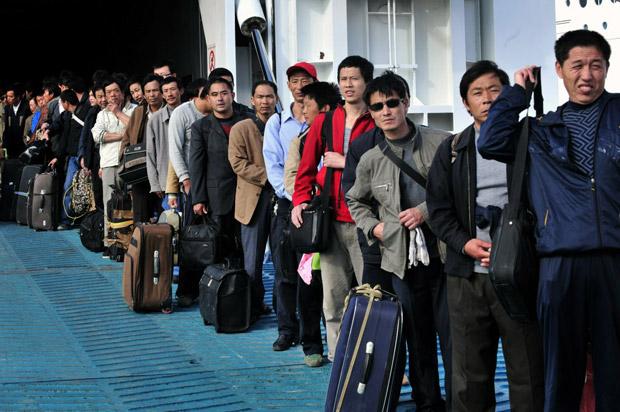 Chinese evacuees from Libya arrive at the port of Heraklion, on the Greek island of Crete, on February 24, 2011. Thousands of Chinese and scores of Europeans began landing at the port of Heraklion after their evacuation from unrest-hit Libya aboard chartered Greek ferries. The first boat from the Libyan port of Benghazi, the ferry Hellenic Spirit, reached Heraklion after 1200 GMT and was followed by the ferry Olympic champion, an AFP photographer reported.