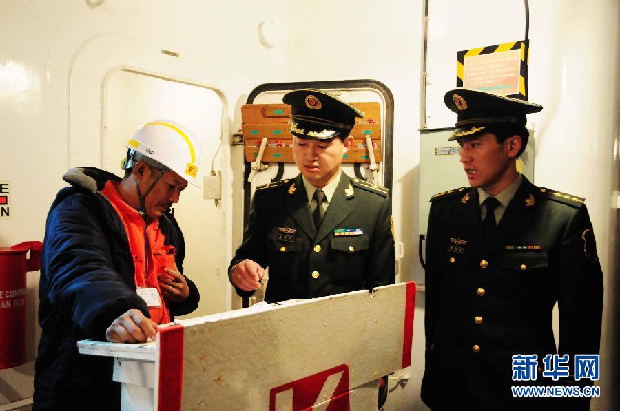 Two coast guards conduct investigation on board the Panama-flagged freighter Hamburg Bridge which docks at the port of Qingdao, east China's Shandong Province, Oct. 29, 2011. The freighter collided with Oriental Sunrise, another Panama-flagged cargo ship, at 7:35 p.m. Friday Beijing Time (1135 GMT) in the nearby waters of Qingdao, causing the latter to sink. Of the 9 rescued crew members on board the Oriental Sunrise, 1 were found dead. Search is in progress for the rest 10, who are still missing. (Xinhua/Yu Fangping) 