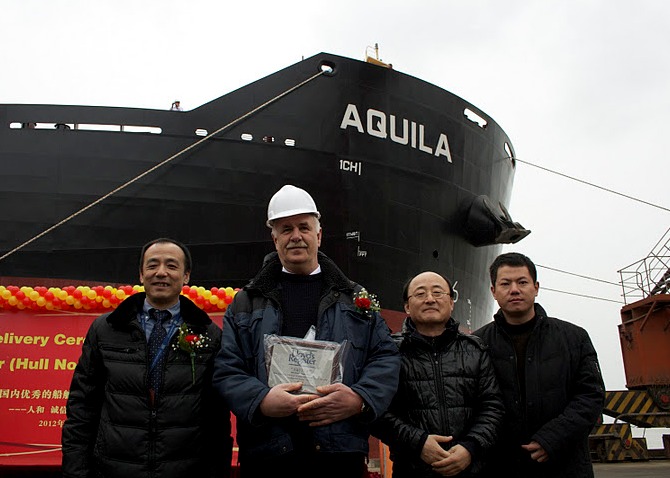 Delivery of ‘ Aquila’: left to right: Zhuang Tian, LR surveyor in charge Nantong; Master - M/V Aquila; Tae-Bok Kwak, LR project manager; Xiaofeng Yang, LR site office team leader