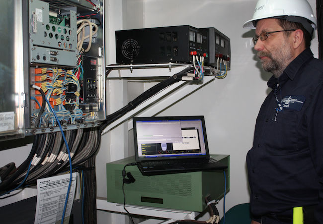 Senior Investigator Luc Charbonneau extracting data from the voyage data recorder aboard the bulk carrier Tundra